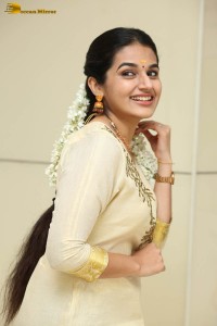 actress aparna janardanan cute looks in a light yellow salwar kameez