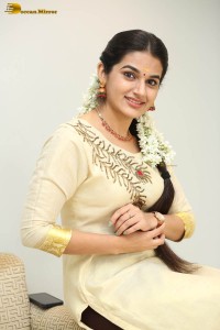 actress aparna janardanan cute looks in a light yellow salwar kameez