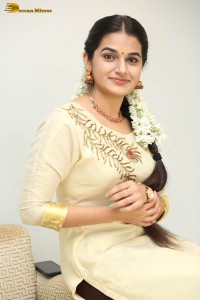 actress aparna janardanan cute looks in a light yellow salwar kameez