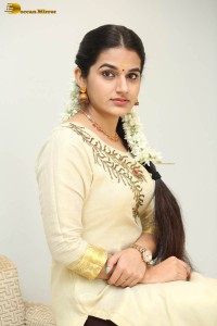 actress aparna janardanan cute looks in a light yellow salwar kameez