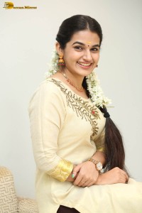 actress aparna janardanan cute looks in a light yellow salwar kameez