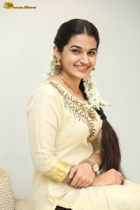 actress aparna janardanan cute looks in a light yellow salwar kameez