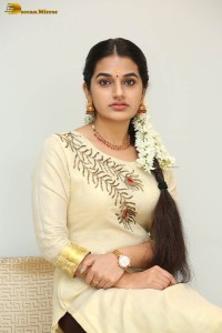 actress aparna janardanan cute looks in a light yellow salwar kameez