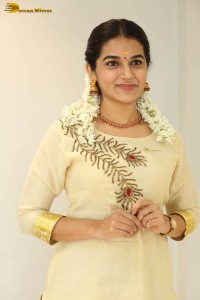 actress aparna janardanan cute looks in a light yellow salwar kameez