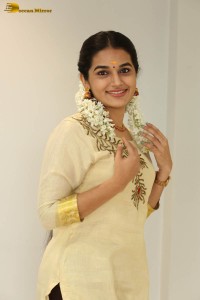 actress aparna janardanan cute looks in a light yellow salwar kameez