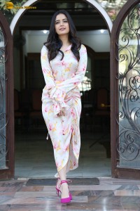 actress ashika ranganath in a white floral dress