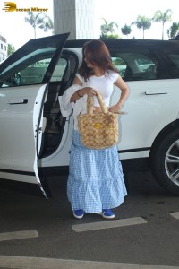 actress Avneet Kaur in a white top and blue skirt at airport