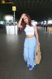 actress Avneet Kaur in a white top and blue skirt at airport