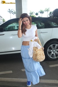 actress Avneet Kaur in a white top and blue skirt at airport
