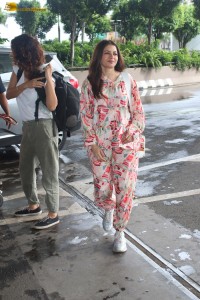 actress bhagyashree in a white and pink floral dress at airport