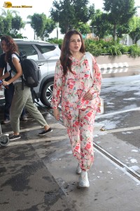 actress bhagyashree in a white and pink floral dress at airport