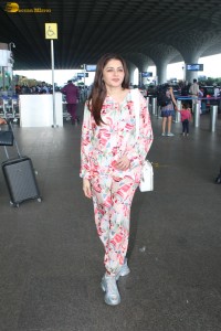 actress bhagyashree in a white and pink floral dress at airport