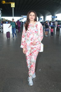 actress bhagyashree in a white and pink floral dress at airport