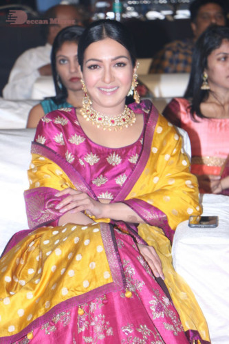Actress Catherine Tresa in a pink dress at an event