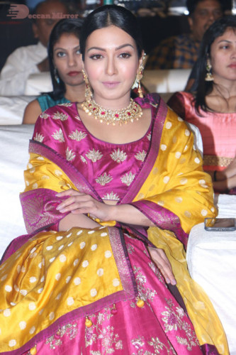 Actress Catherine Tresa in a pink dress at an event