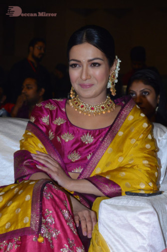 Actress Catherine Tresa in a pink dress at an event