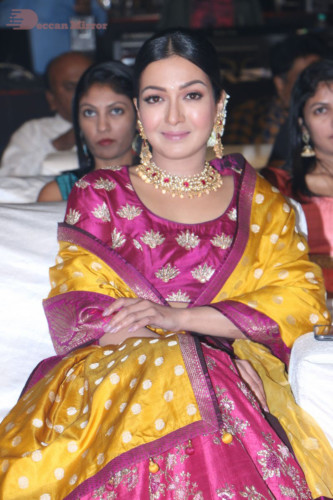 Actress Catherine Tresa in a pink dress at an event