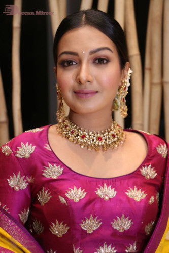 Actress Catherine Tresa in a pink dress at an event