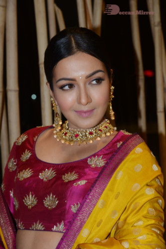 Actress Catherine Tresa in a pink dress at an event