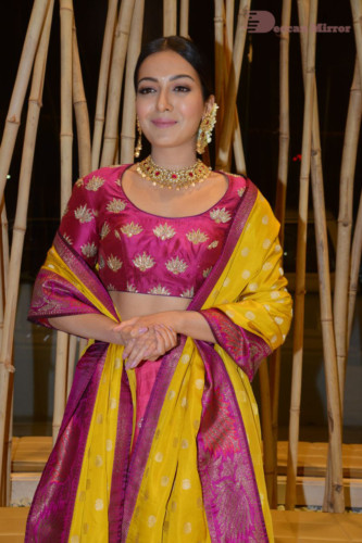 Actress Catherine Tresa in a pink dress at an event