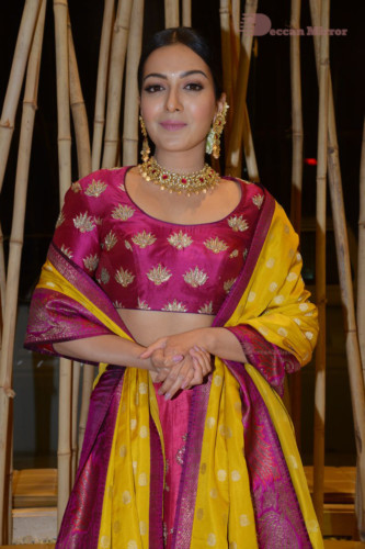 Actress Catherine Tresa in a pink dress at an event