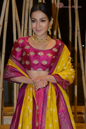 Actress Catherine Tresa in a pink dress at an event