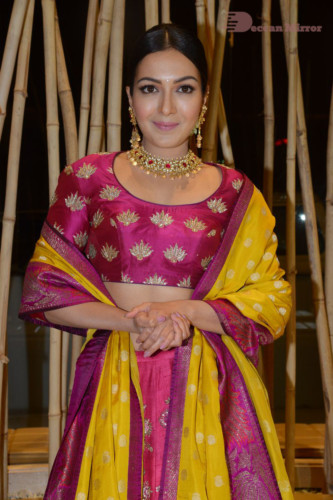 Actress Catherine Tresa in a pink dress at an event