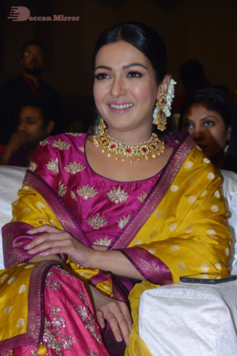 Actress Catherine Tresa in a pink dress at an event