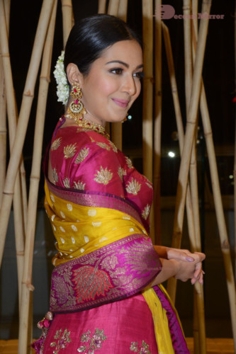 Actress Catherine Tresa in a pink dress at an event