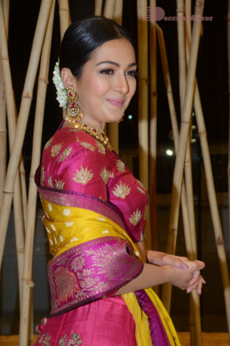 Actress Catherine Tresa in a pink dress at an event
