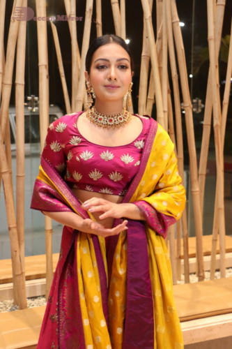 Actress Catherine Tresa in a pink dress at an event