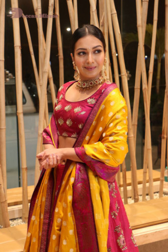 Actress Catherine Tresa in a pink dress at an event