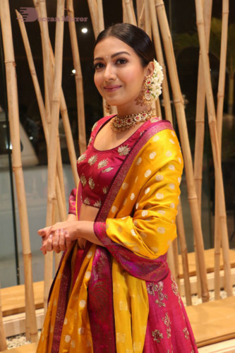 Actress Catherine Tresa in a pink dress at an event