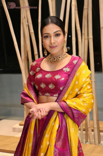 Actress Catherine Tresa in a pink dress at an event