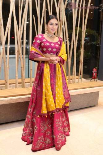 Actress Catherine Tresa in a pink dress at an event