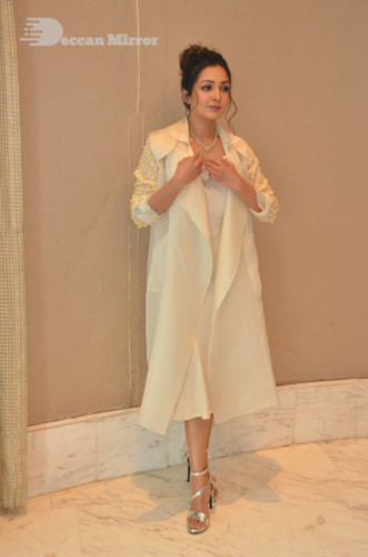 Picture of Actress Catherine Tresa photoshoot dressed in a white overcoat