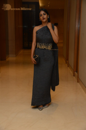 Actress Chandini Chowdary in a grey dress