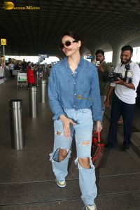 Indian model and actress Daisy Shah in a blue shirt and jeans at mumbai airport