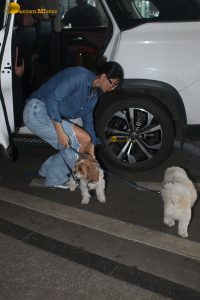 Indian model and actress Daisy Shah in a blue shirt and jeans at mumbai airport