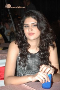 Actress Deeksha Seth dressed in black and white attending a cinema event