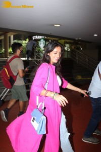 Indian actress deepika singh in a pink coat and blue jeans at airport
