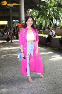 Indian actress deepika singh in a pink coat and blue jeans at airport