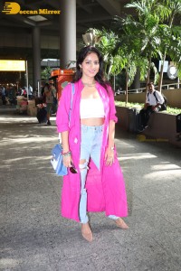 Indian actress deepika singh in a pink coat and blue jeans at airport