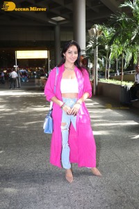 Indian actress deepika singh in a pink coat and blue jeans at airport