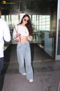 actress Disha Patani in a white top and denim jeans