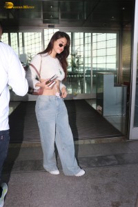 actress Disha Patani in a white top and denim jeans