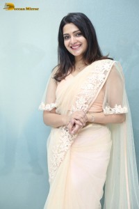 Telugu Actress Divya Pillai in a light pink saree posing for pictures