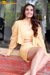 Actress Divyansha Kaushik in a orange skirt and suit