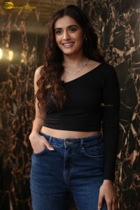 actress divyansha kaushik in a black top and denim jeans