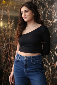 actress divyansha kaushik in a black top and denim jeans